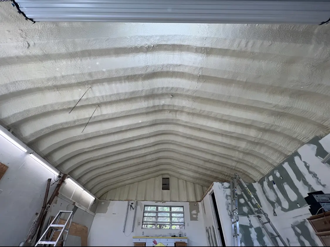Spray polyurethane foam applied to the underside of a metal roof deck in Pensacola Station
